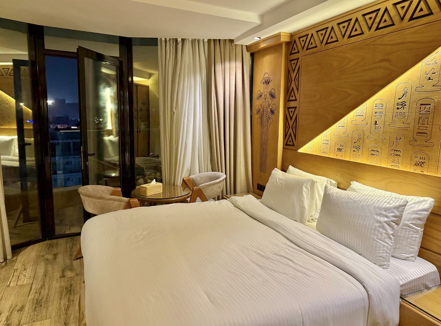 A guest room at the Giza hotel with Egyptian carved headboard